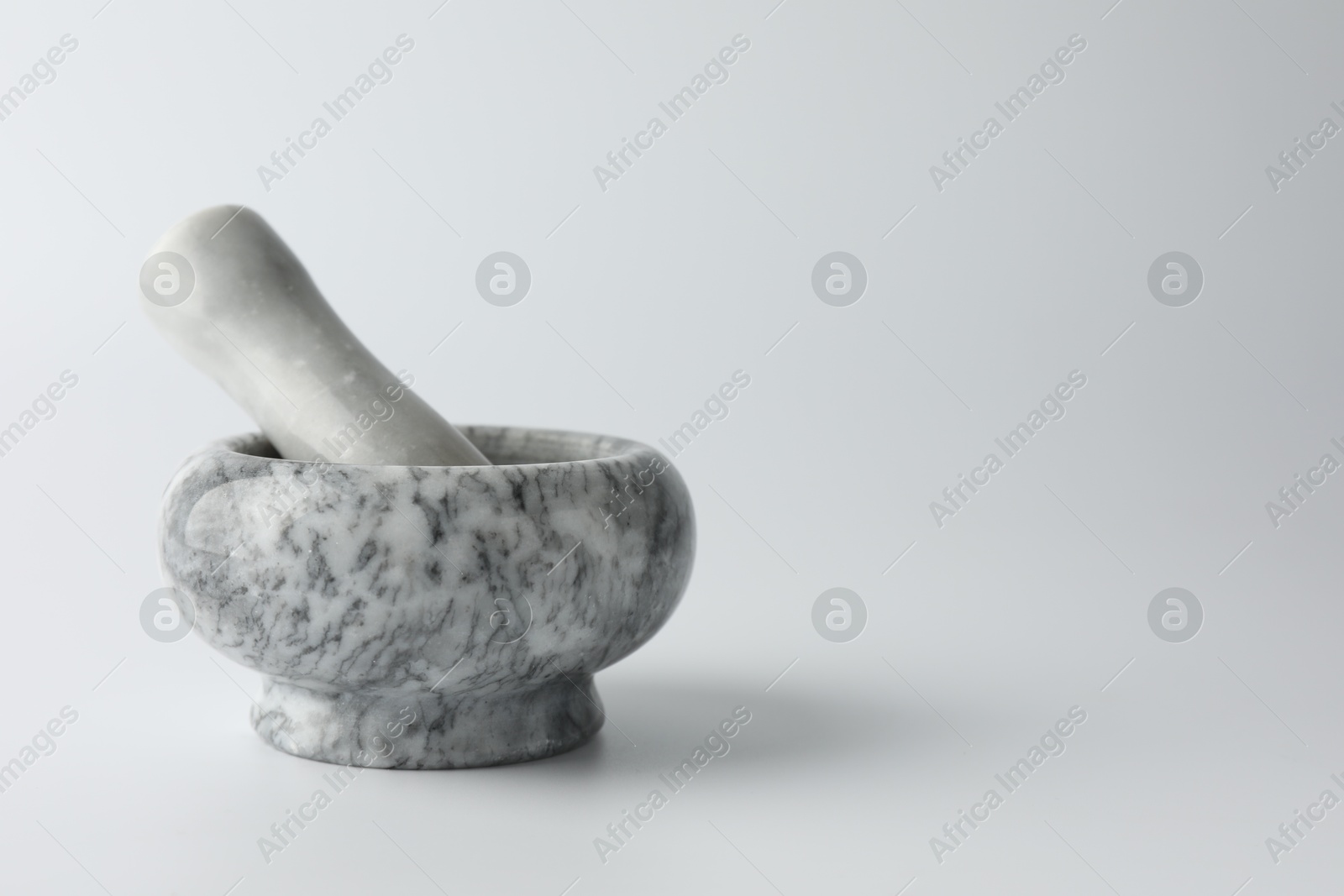 Marble mortar with pestle on white background, space for text Photo of Marble mortar with pestle on white background, space for text