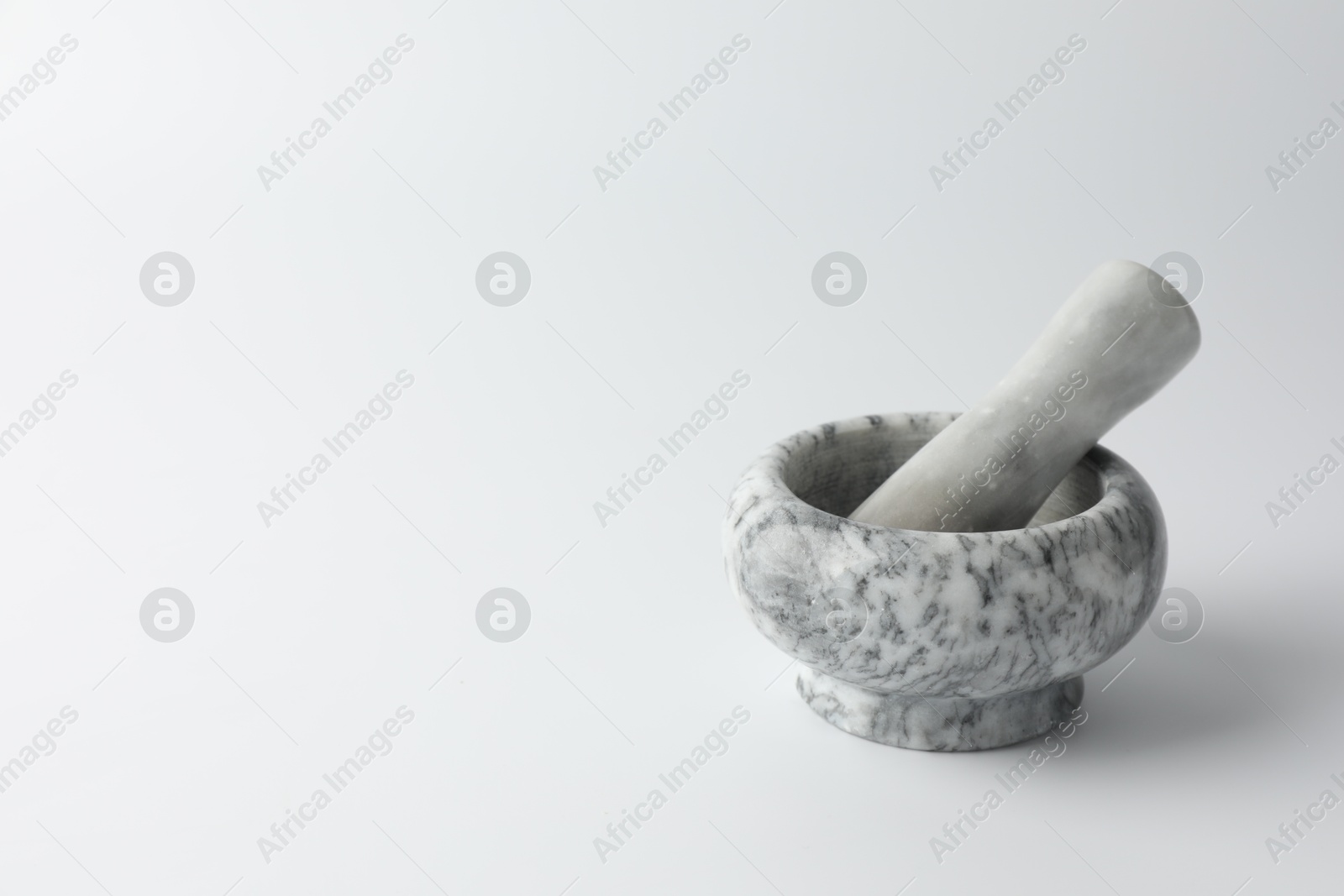 Marble mortar with pestle on white background, space for text Photo of Marble mortar with pestle on white background, space for text