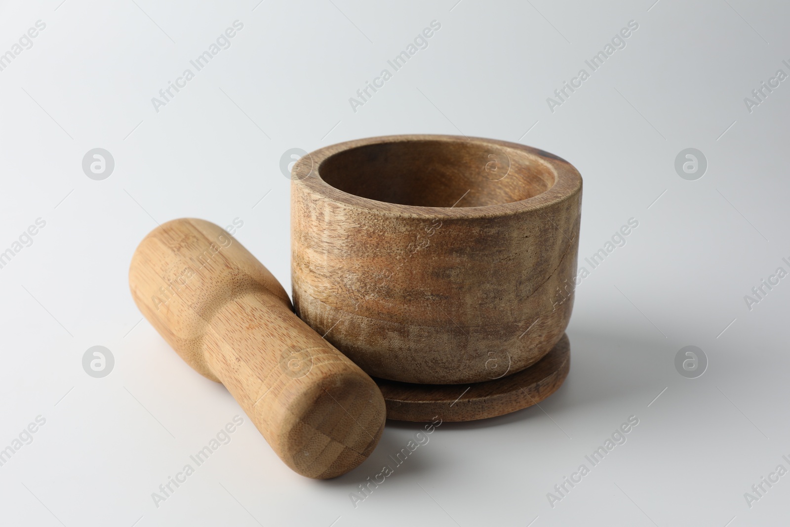 Wooden mortar with pestle on white background, closeup Photo of Wooden mortar with pestle on white background, closeup