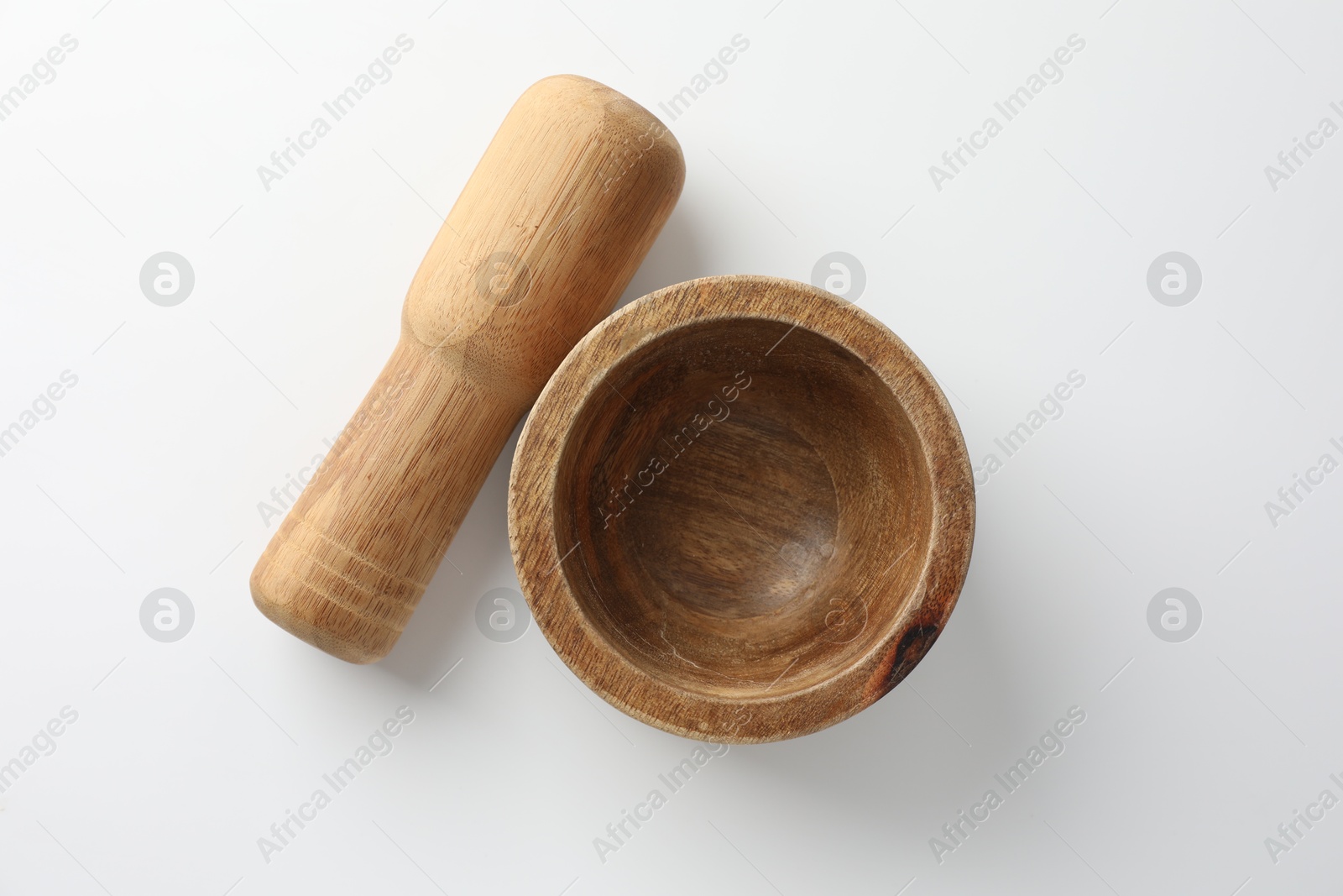 Wooden mortar with pestle on white background, flat lay Photo of Wooden mortar with pestle on white background, flat lay