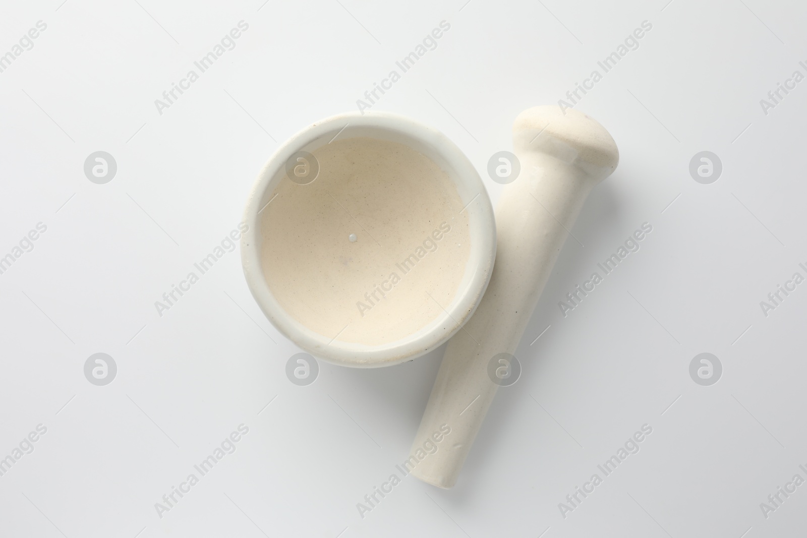 Ceramic mortar with pestle on white background, flat lay Photo of Ceramic mortar with pestle on white background, flat lay