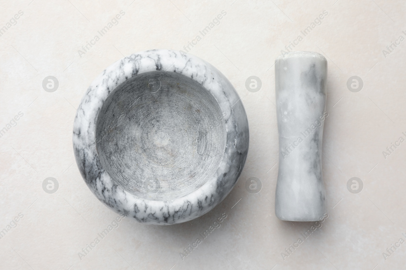Marble mortar and pestle on white table, top view Photo of Marble mortar and pestle on white table, top view