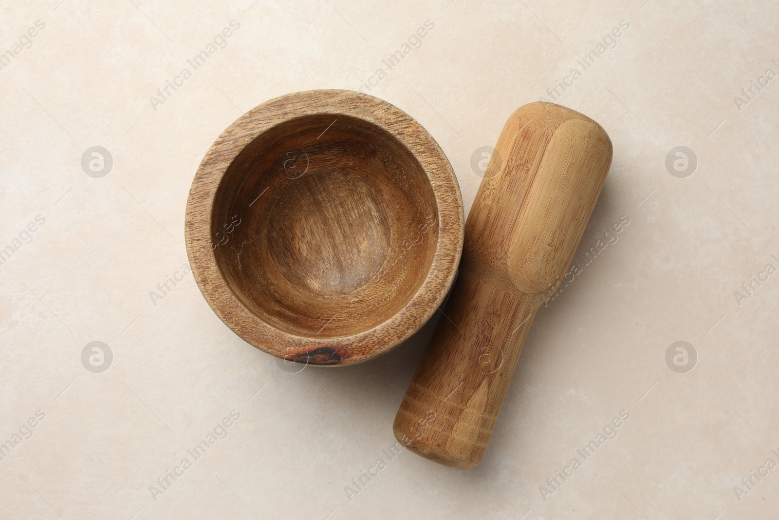 Wooden mortar and pestle on white table, top view Photo of Wooden mortar and pestle on white table, top view