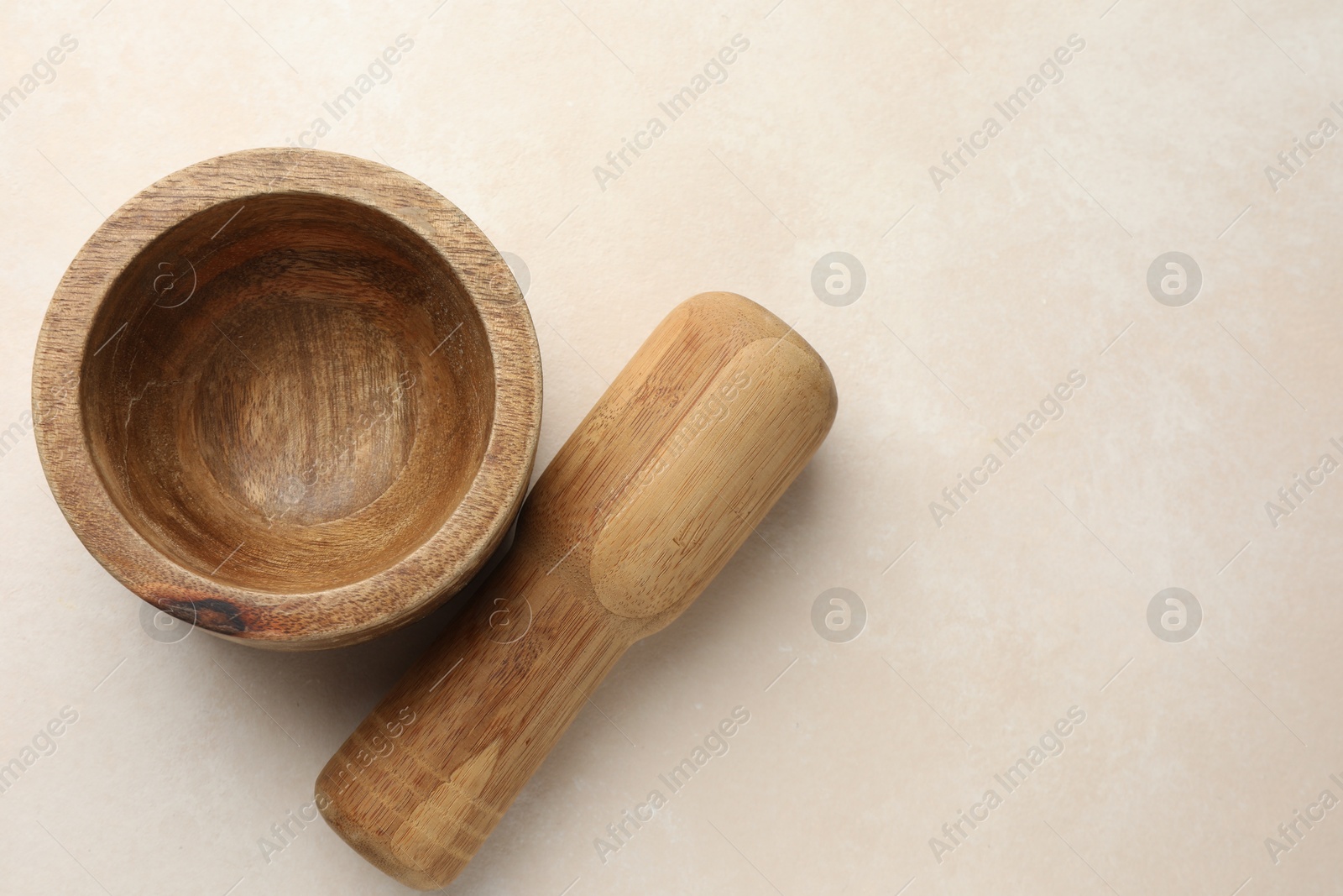 Wooden mortar and pestle on white table, top view. Space for text Photo of Wooden mortar and pestle on white table, top view. Space for text