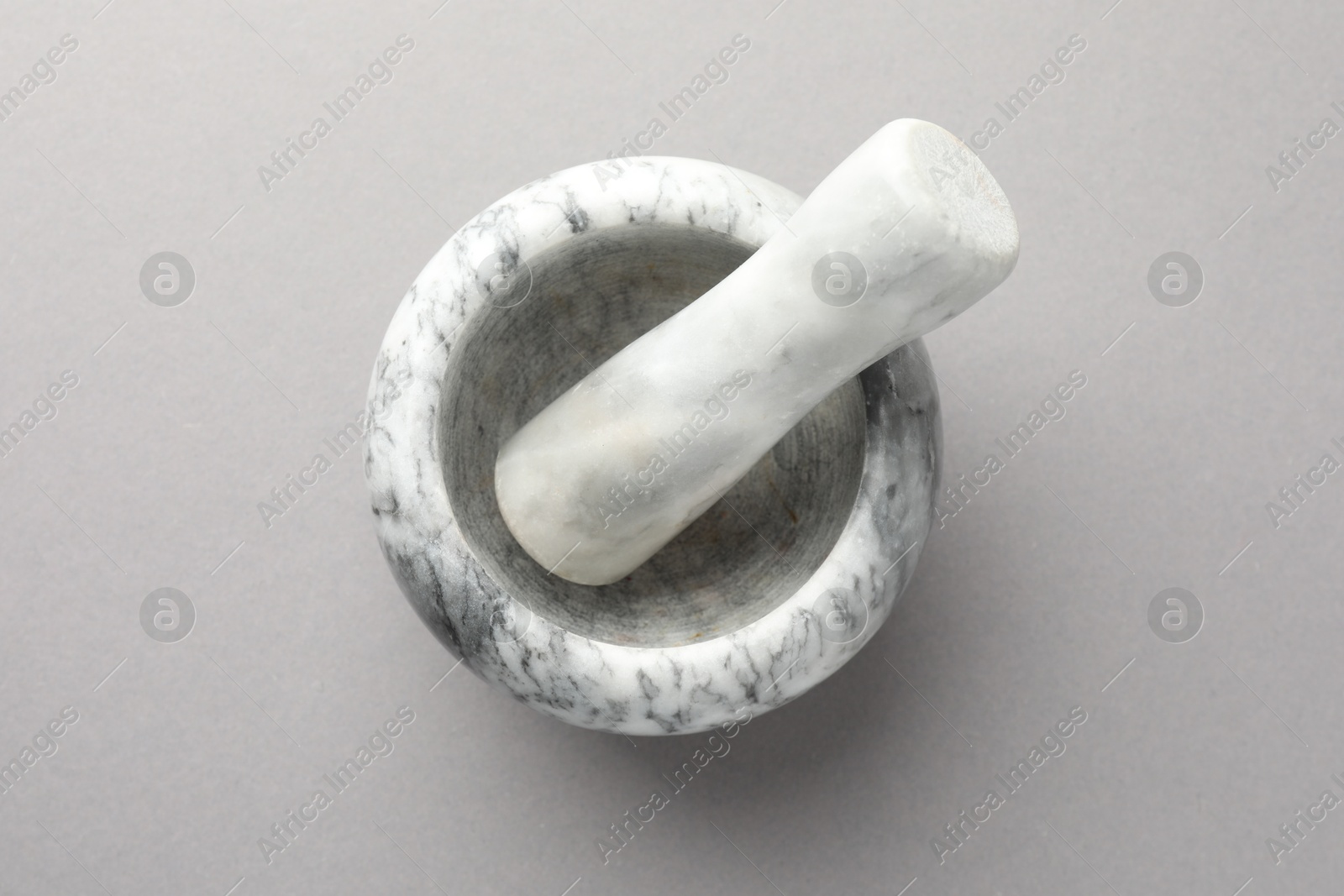 Marble mortar and pestle on light grey background, top view Photo of Marble mortar and pestle on light grey background, top view