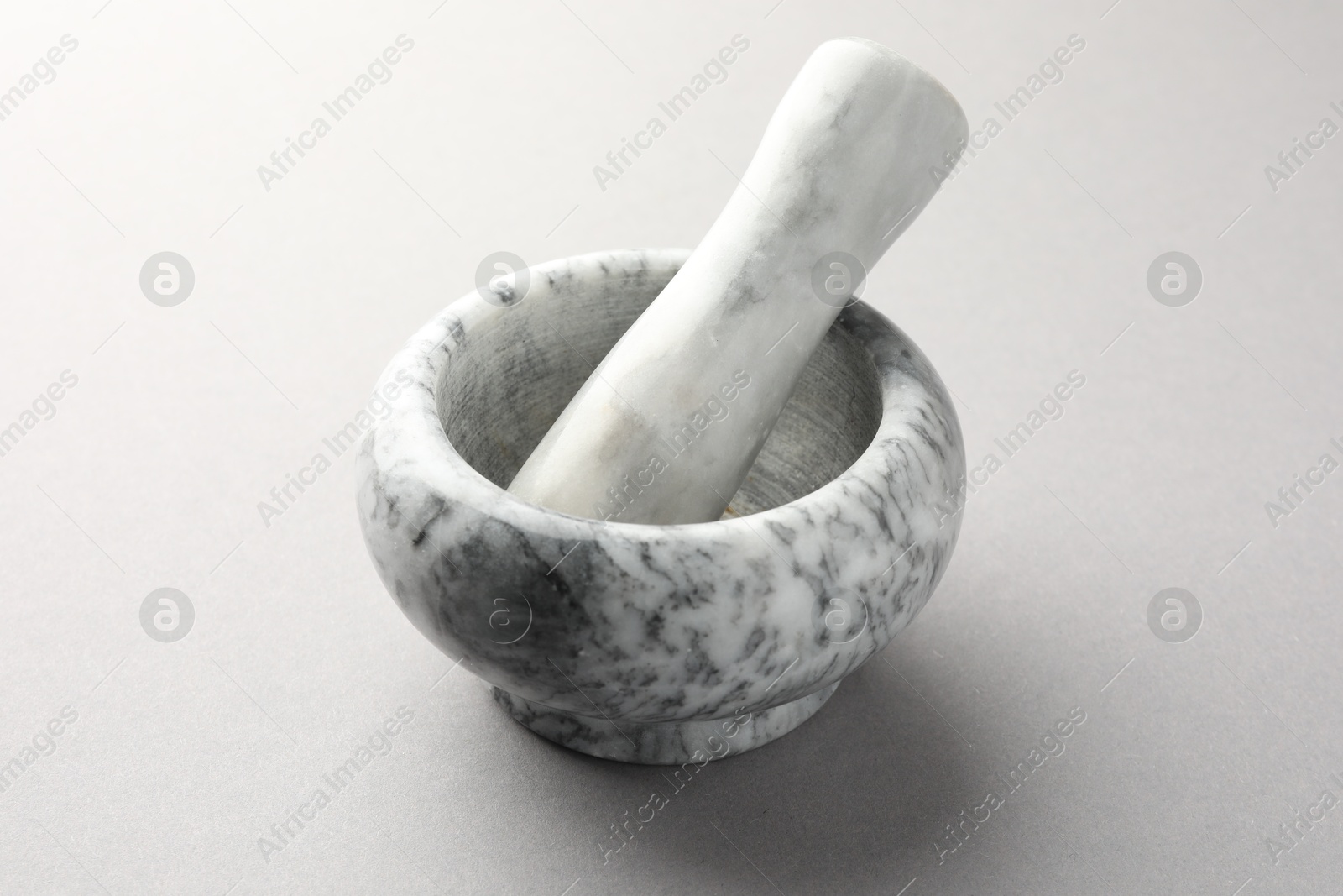 Marble mortar and pestle on light grey background, closeup Photo of Marble mortar and pestle on light grey background, closeup