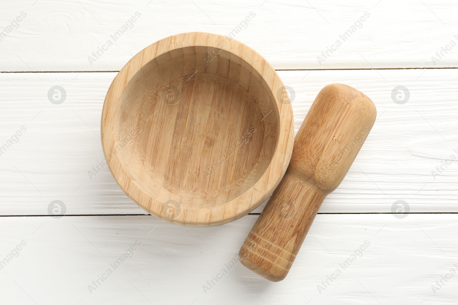 Mortar and pestle on white wooden table, top view Photo of Mortar and pestle on white wooden table, top view