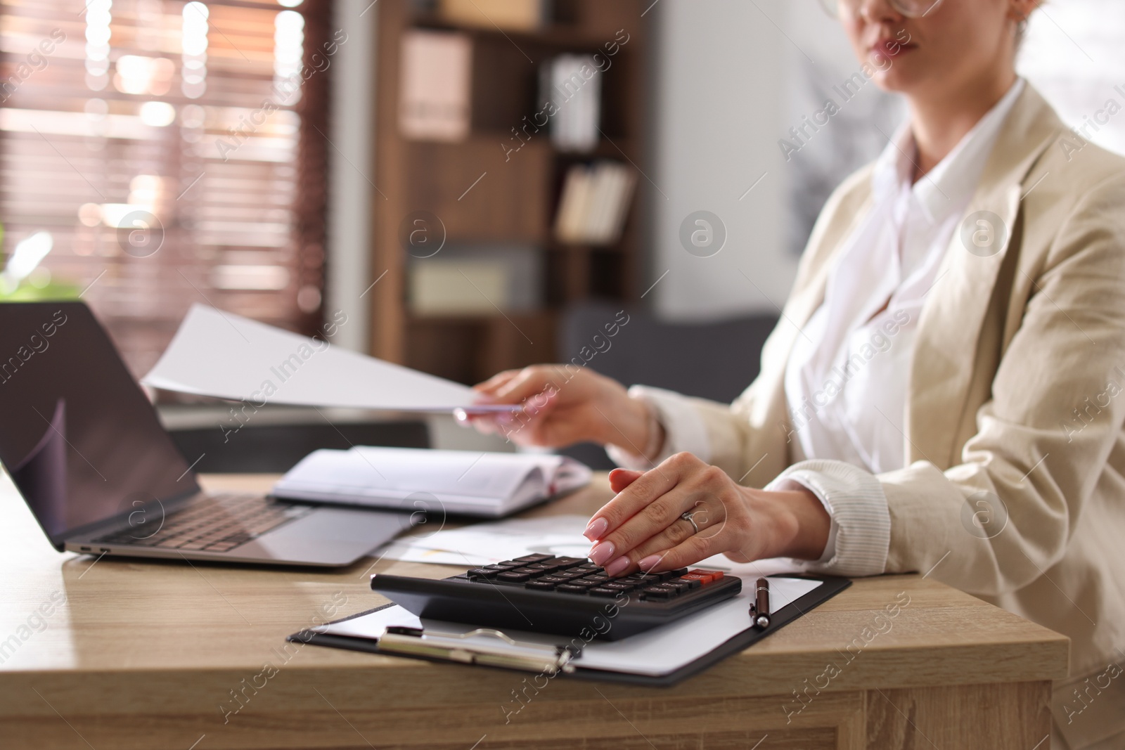 Professional banker working at desk in office, closeup Photo of Professional banker working at desk in office, closeup