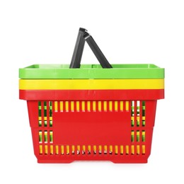 Photo of Stack of colorful shopping baskets isolated on white