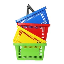 Photo of Stack of colorful shopping baskets isolated on white