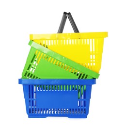 Photo of Stack of colorful shopping baskets isolated on white