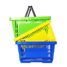 Photo of Stack of colorful shopping baskets isolated on white