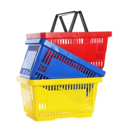 Photo of Stack of colorful shopping baskets isolated on white