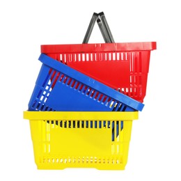 Photo of Stack of colorful shopping baskets isolated on white