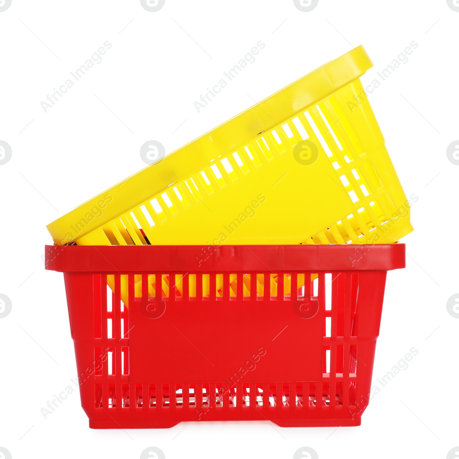 Stack of colorful shopping baskets isolated on white Photo of Stack of colorful shopping baskets isolated on white