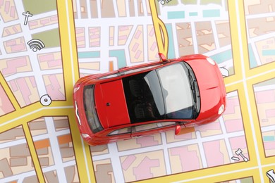 Photo of Road trip concept. Toy car on city map, top view