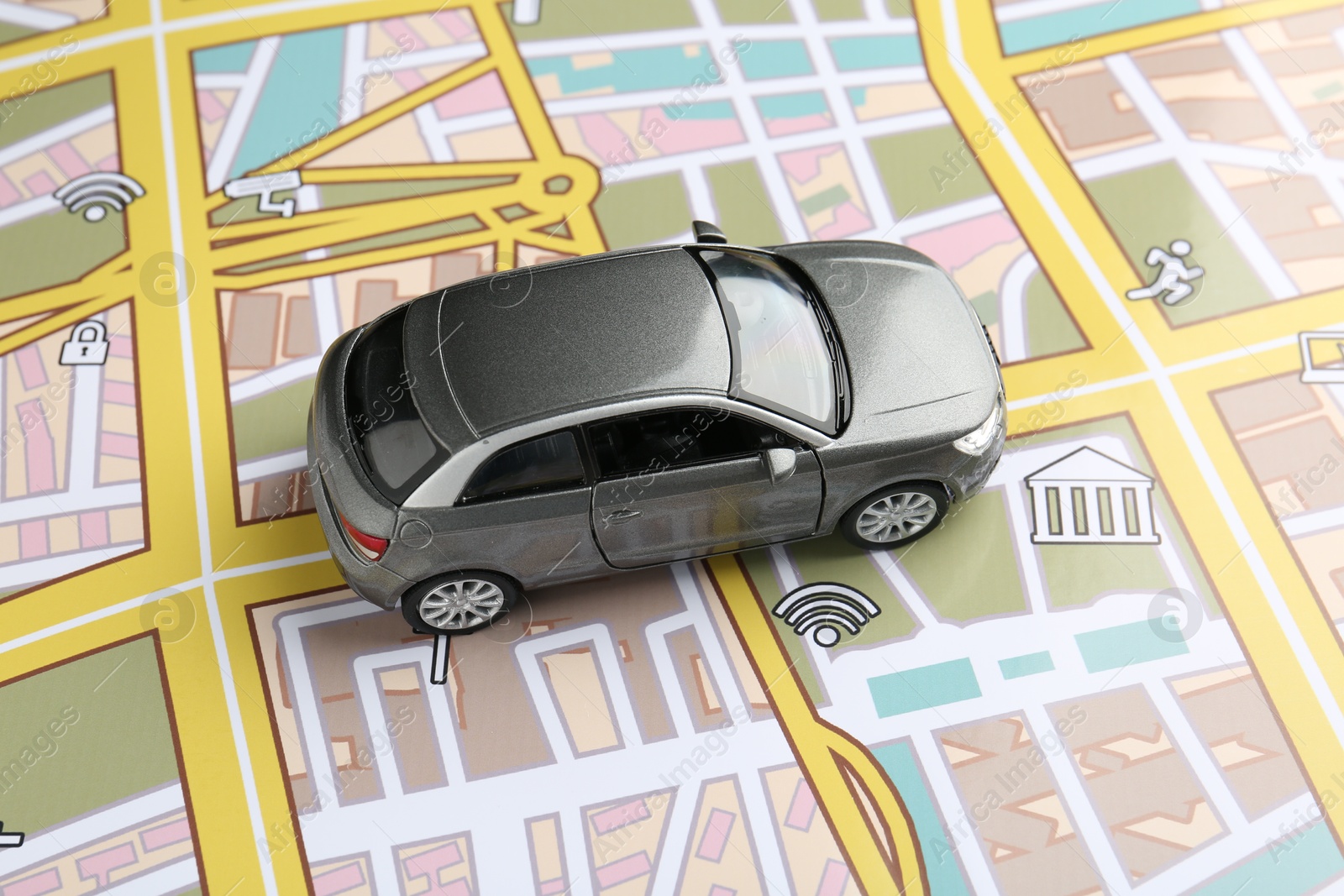 Road trip concept. Toy car on city map, above view Photo of Road trip concept. Toy car on city map, above view