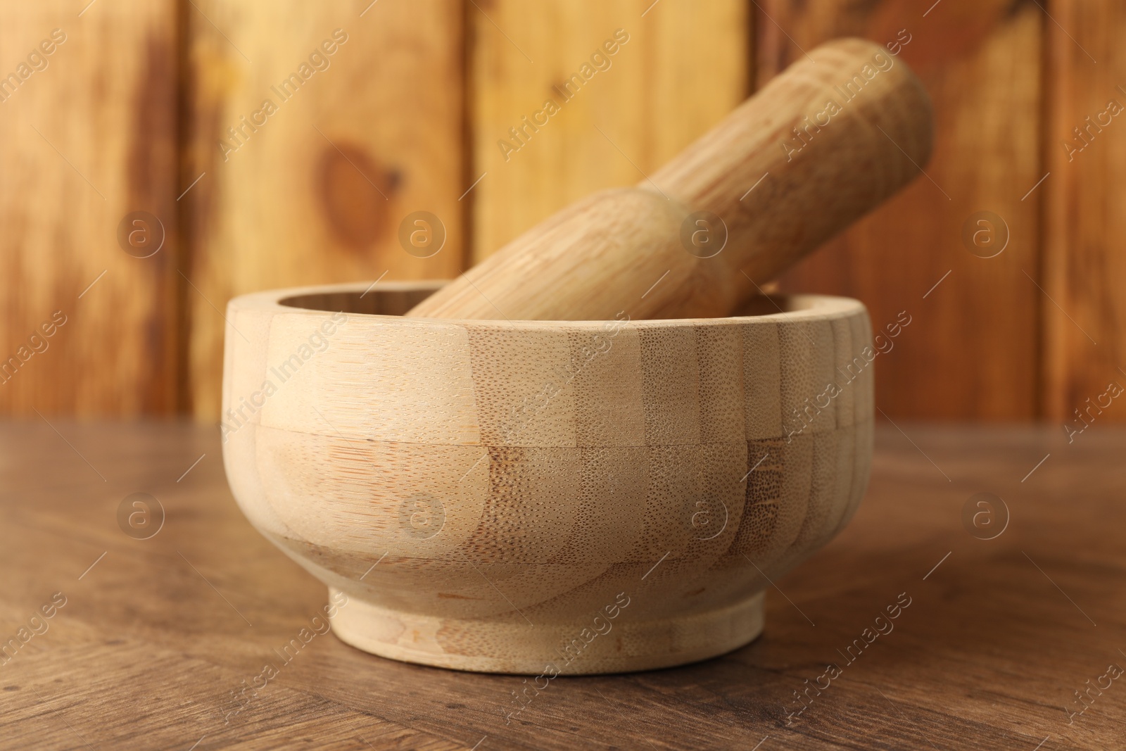 Mortar and pestle on wooden table, closeup Photo of Mortar and pestle on wooden table, closeup