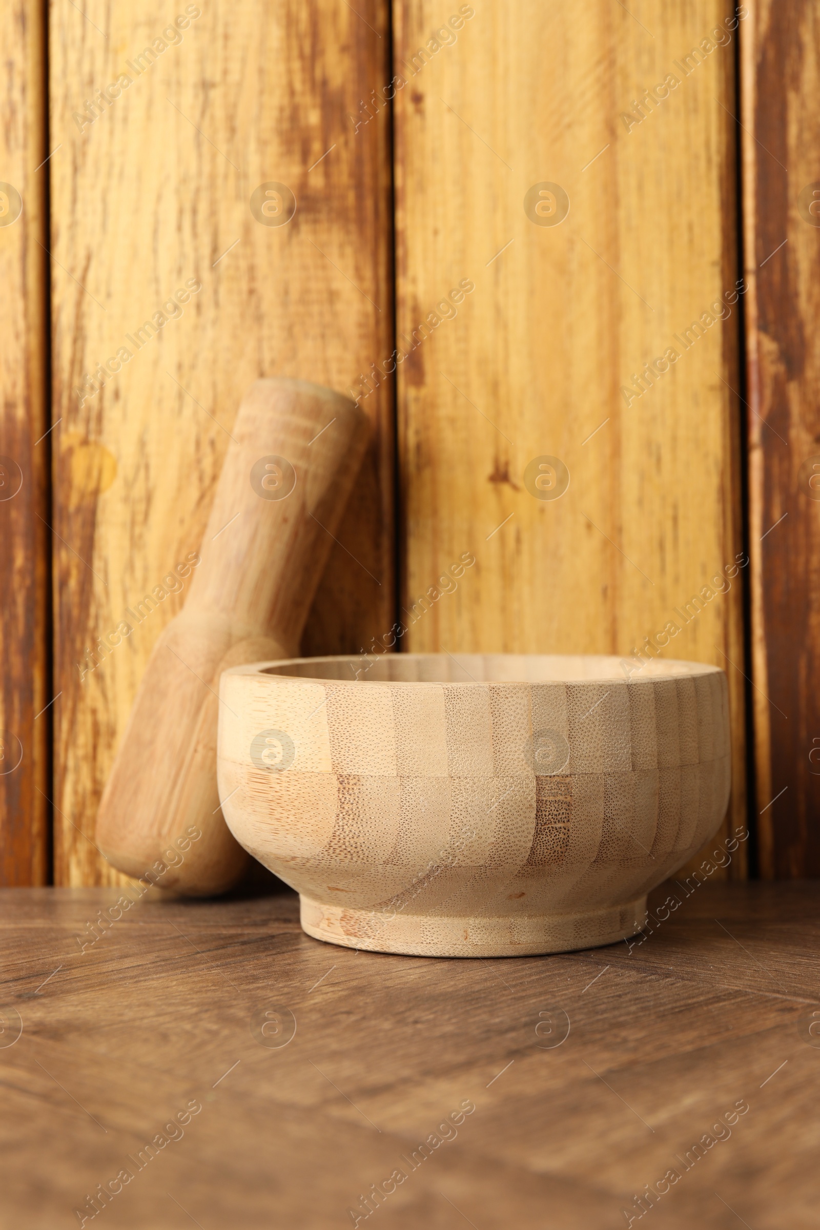 Mortar and pestle on wooden table. Cooking utensil Photo of Mortar and pestle on wooden table. Cooking utensil