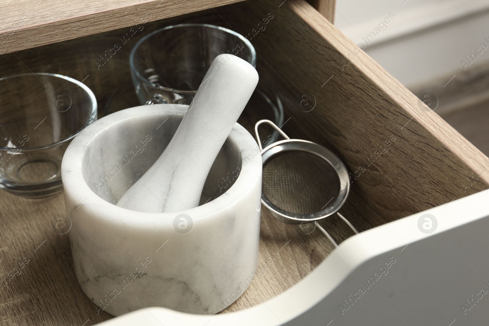 Marble mortar and pestle in drawer indoors, closeup Photo of Marble mortar and pestle in drawer indoors, closeup