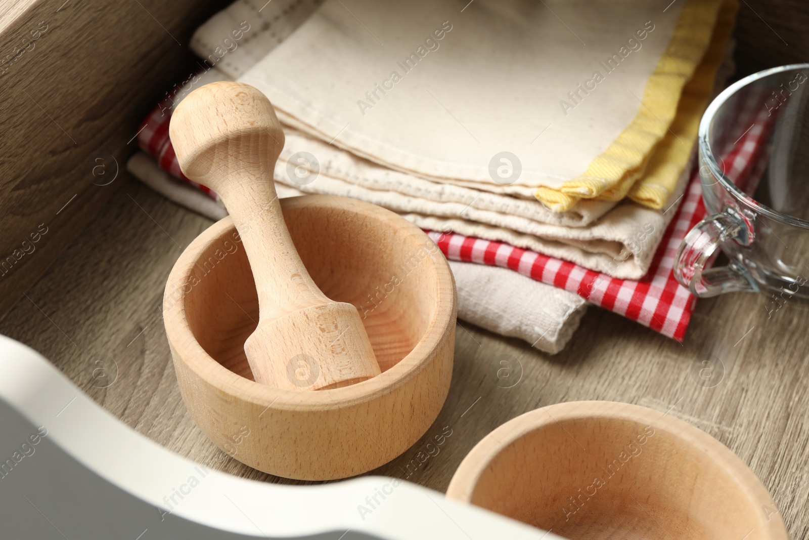Wooden mortar and pestle in drawer indoors, closeup Photo of Wooden mortar and pestle in drawer indoors, closeup
