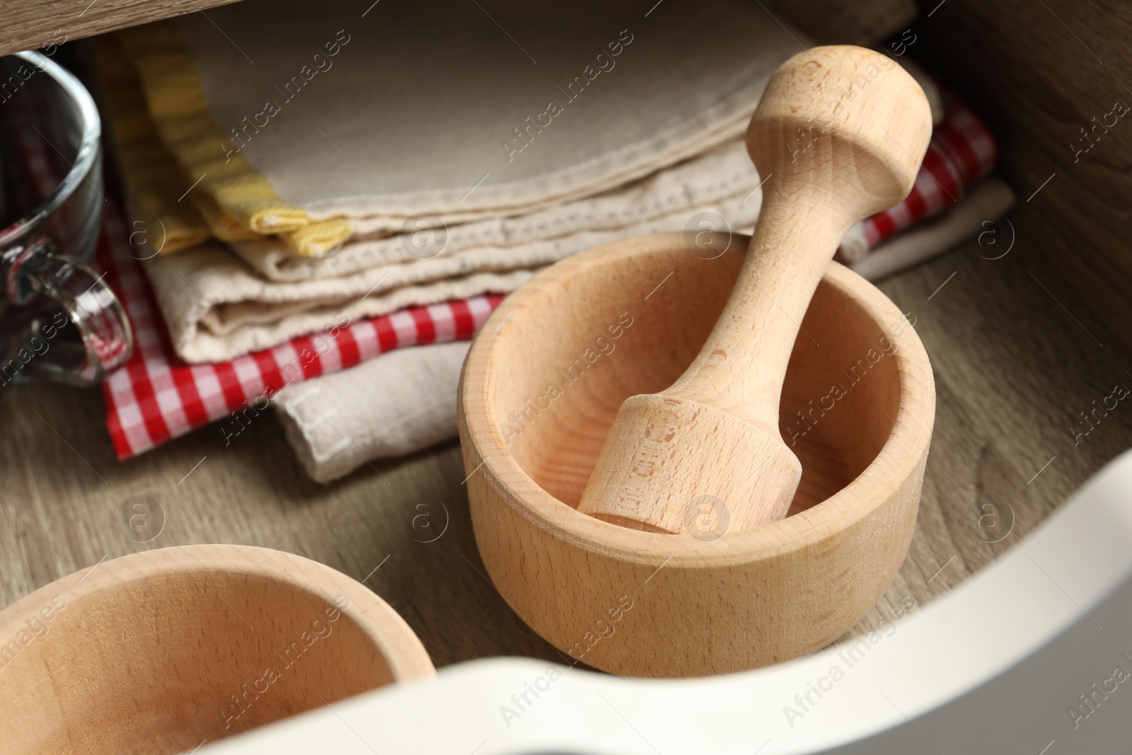 Wooden mortar and pestle in drawer indoors, closeup Photo of Wooden mortar and pestle in drawer indoors, closeup