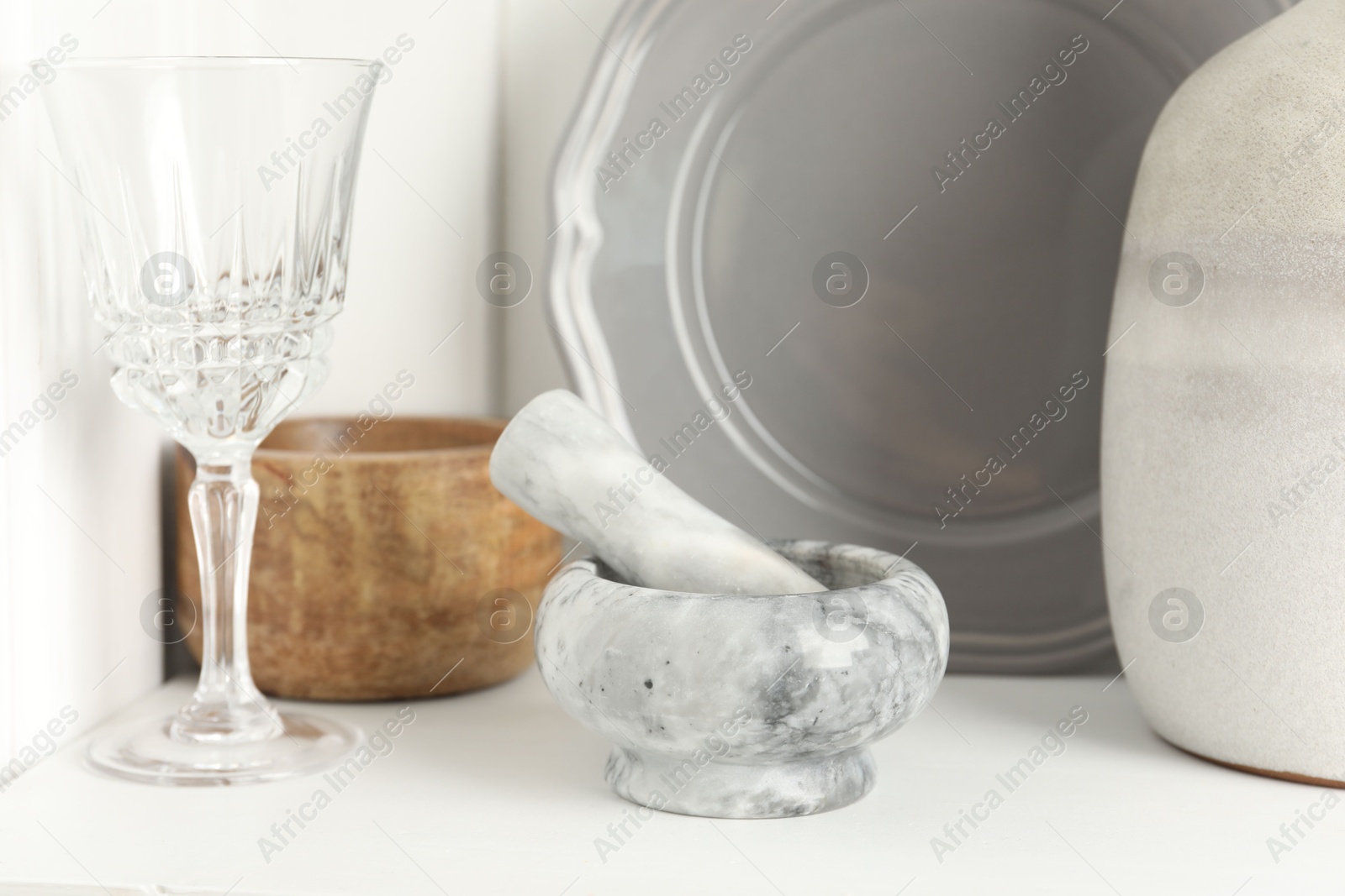 Marble mortar and pestle on white table indoors, closeup Photo of Marble mortar and pestle on white table indoors, closeup
