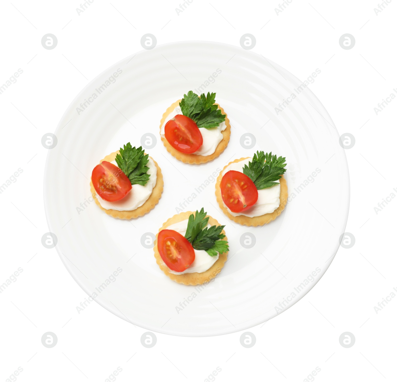Photo of Tasty crackers with cream cheese, tomatoes and parsley isolated on white, top view