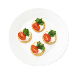 Photo of Tasty crackers with cream cheese, tomatoes and parsley isolated on white, top view