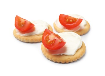 Photo of Tasty crackers with cream cheese and tomatoes isolated on white