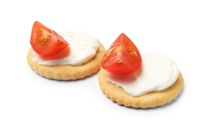 Photo of Tasty crackers with cream cheese and tomatoes isolated on white