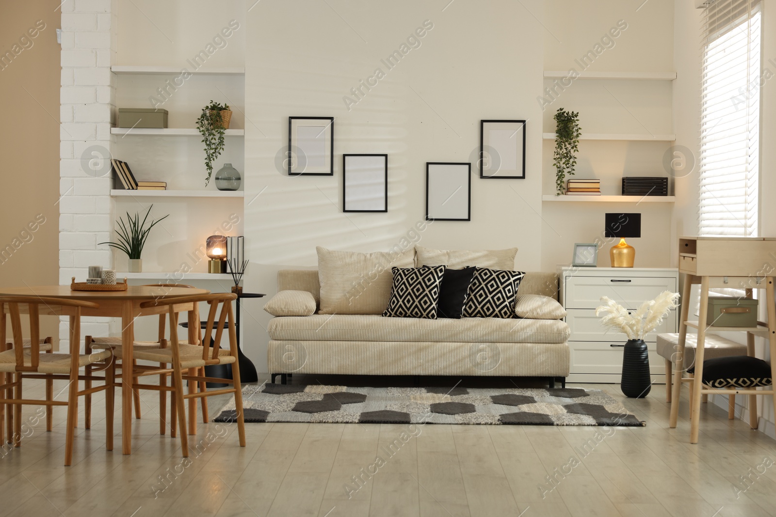 Comfortable sofa, table, chairs and dresser indoors. Interior design Photo of Comfortable sofa, table, chairs and dresser indoors. Interior design