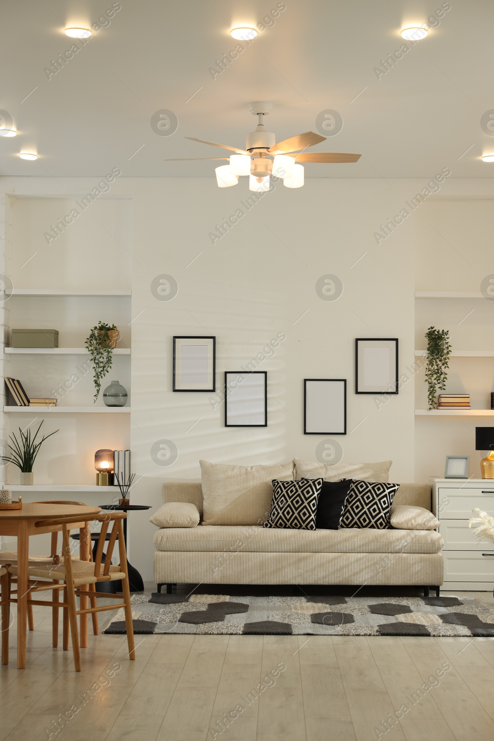 Comfortable sofa, table, chairs and dresser indoors. Interior design Photo of Comfortable sofa, table, chairs and dresser indoors. Interior design