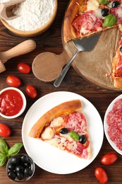 Photo of Tasty pizza and ingredients on wooden table, flat lay