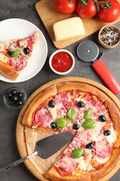 Photo of Tasty pizza and ingredients on grey table, flat lay