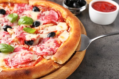 Photo of Tasty pizza served on grey table, closeup