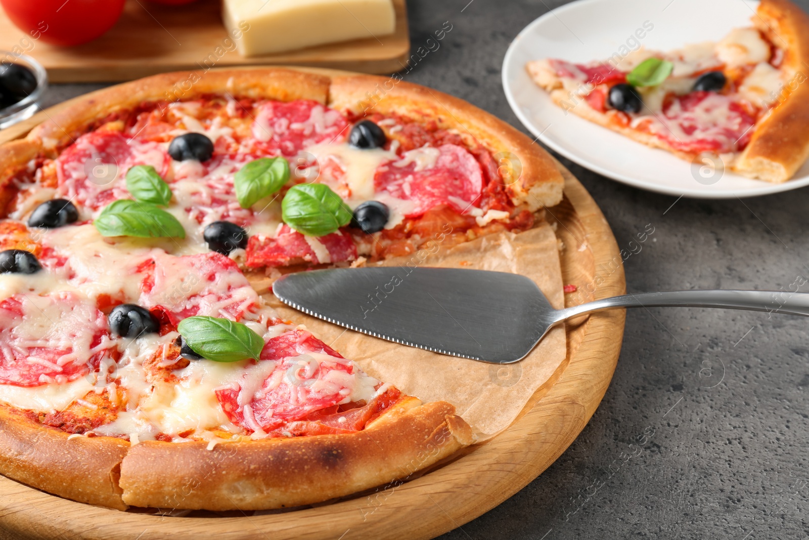 Tasty pizza served on grey table, closeup Photo of Tasty pizza served on grey table, closeup