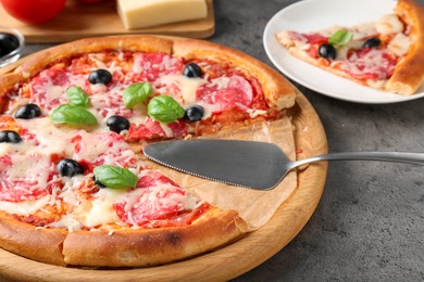 Photo of Tasty pizza served on grey table, closeup