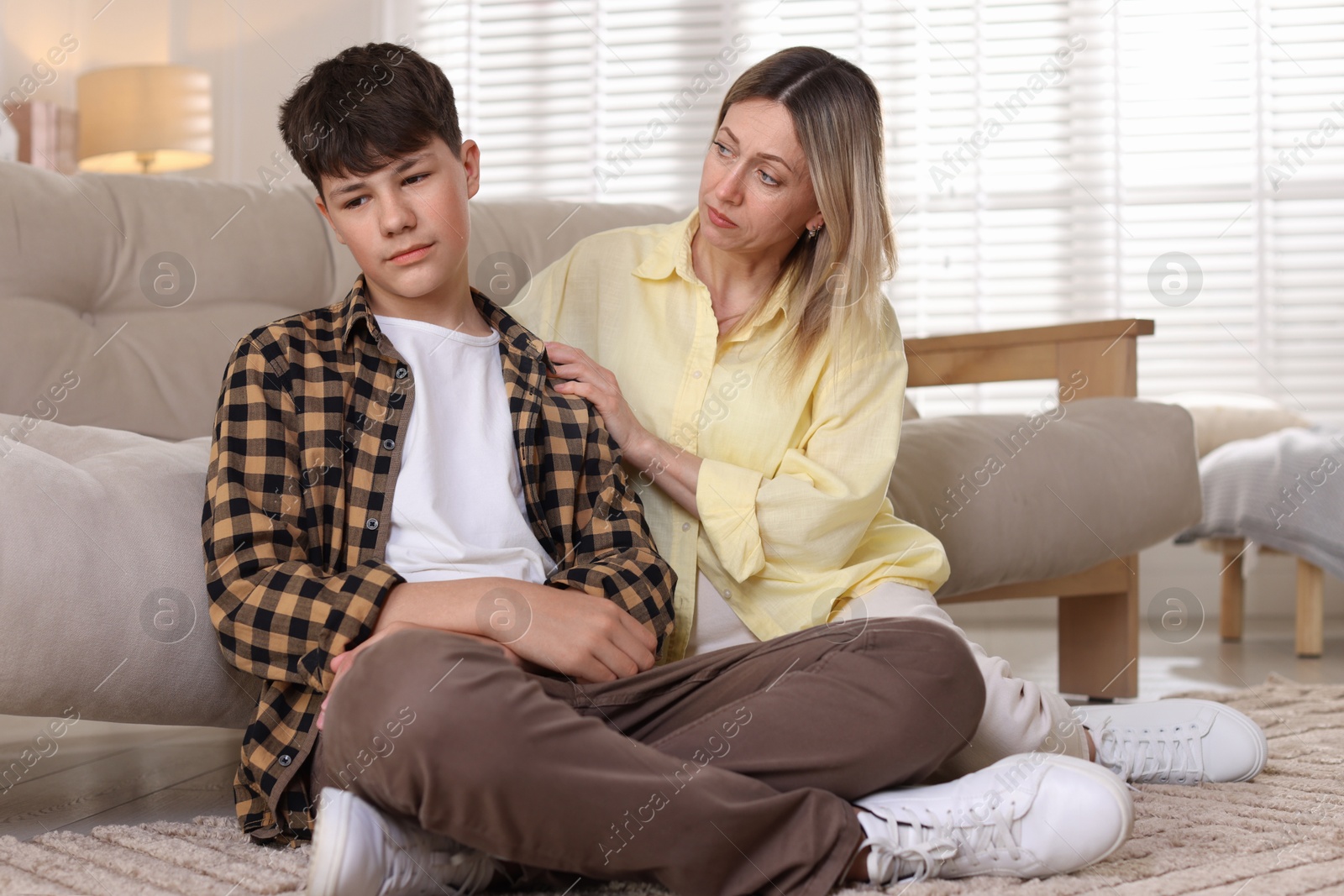 Photo of Mother consoling her upset son at home