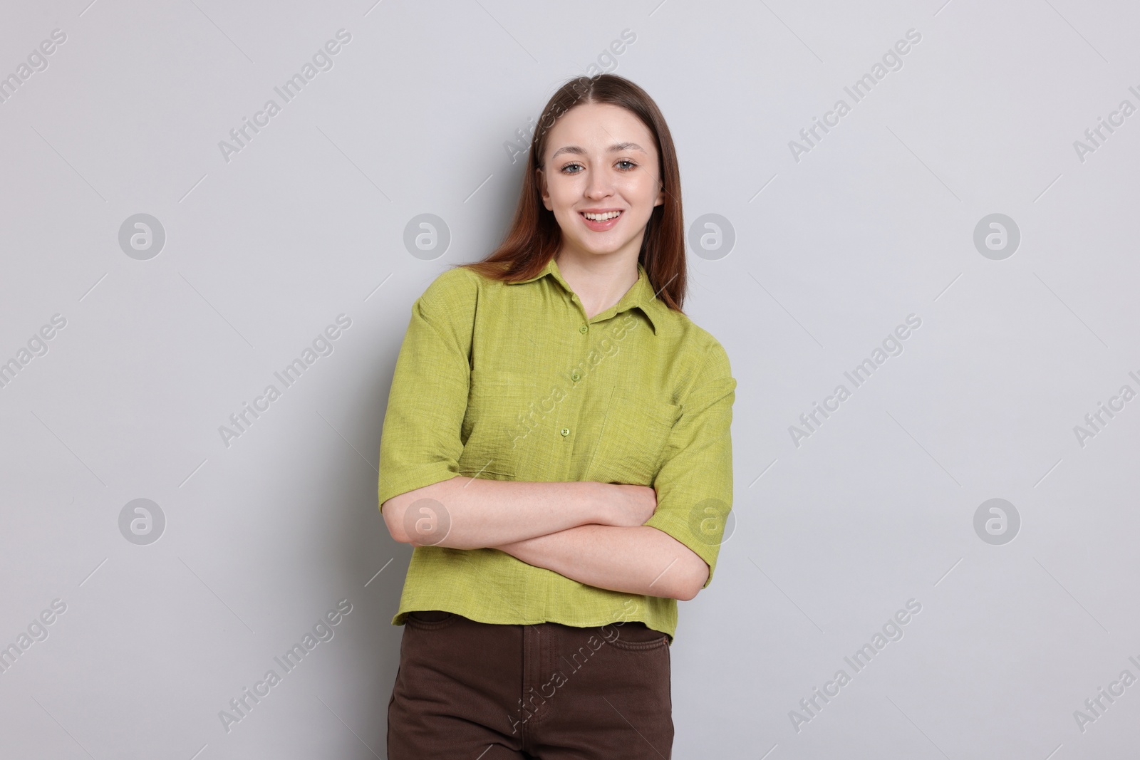 Photo of Portrait of happy teenage girl on light grey background