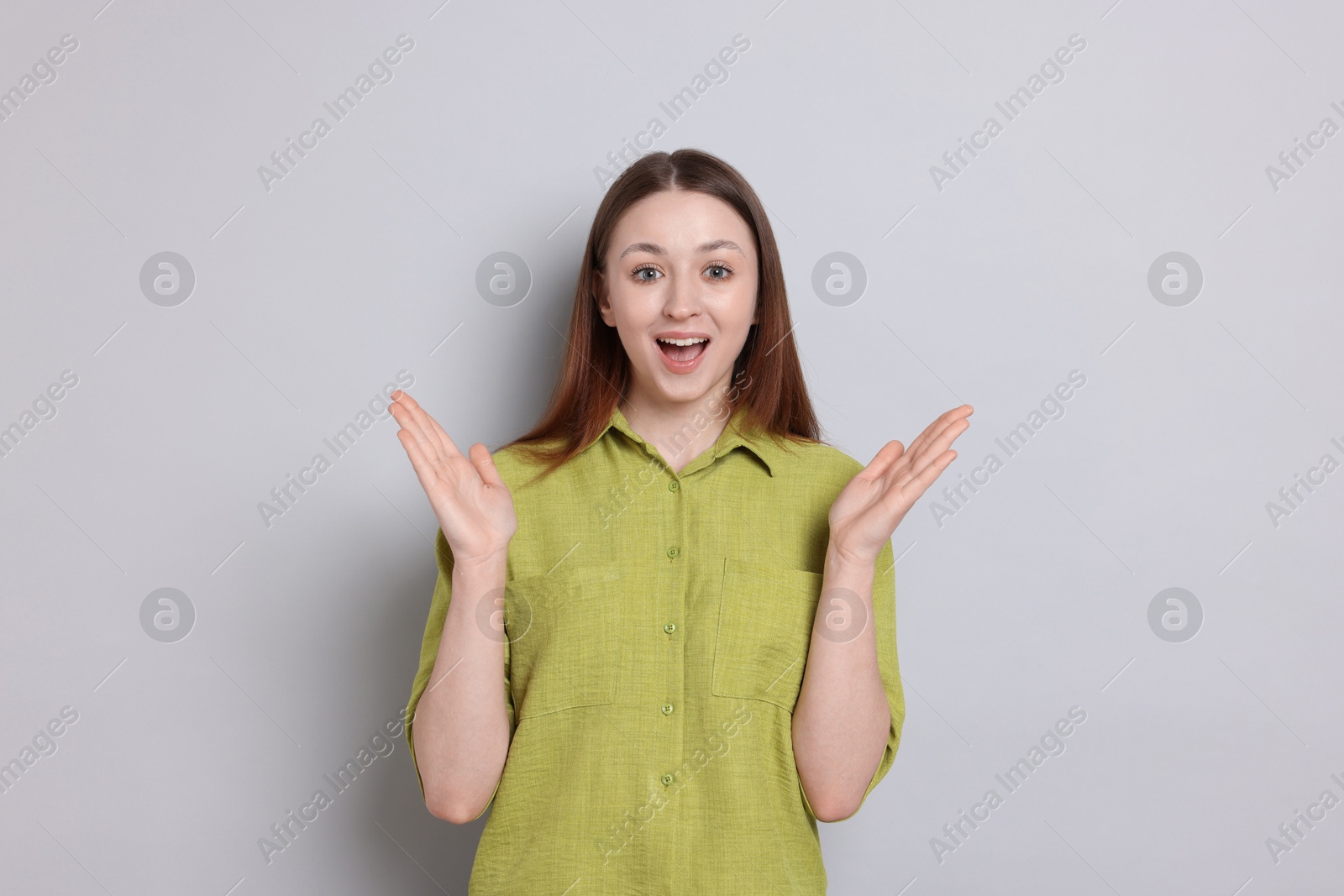 Happy teenage girl on light grey background Photo of Happy teenage girl on light grey background