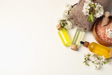 Photo of Spa composition with cosmetic products and beautiful flowers on white table, flat lay. Space for text