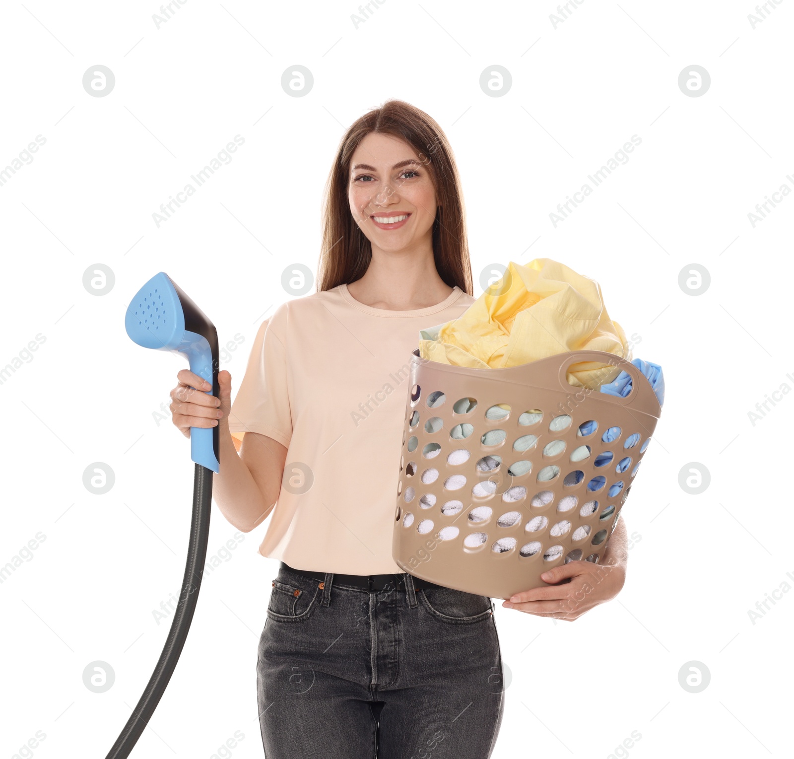 Smiling woman with steamer and basket with clothes on white background Photo of Smiling woman with steamer and basket with clothes on white background