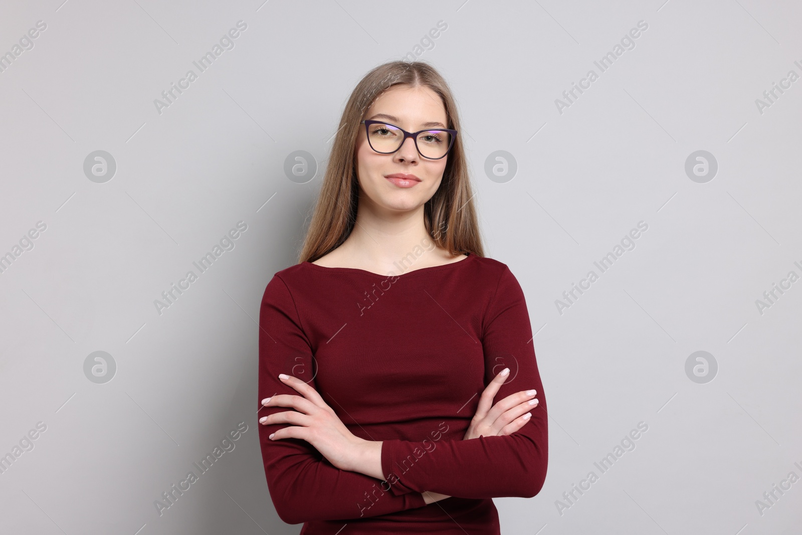 Portrait of teenage girl on light grey background Photo of Portrait of teenage girl on light grey background