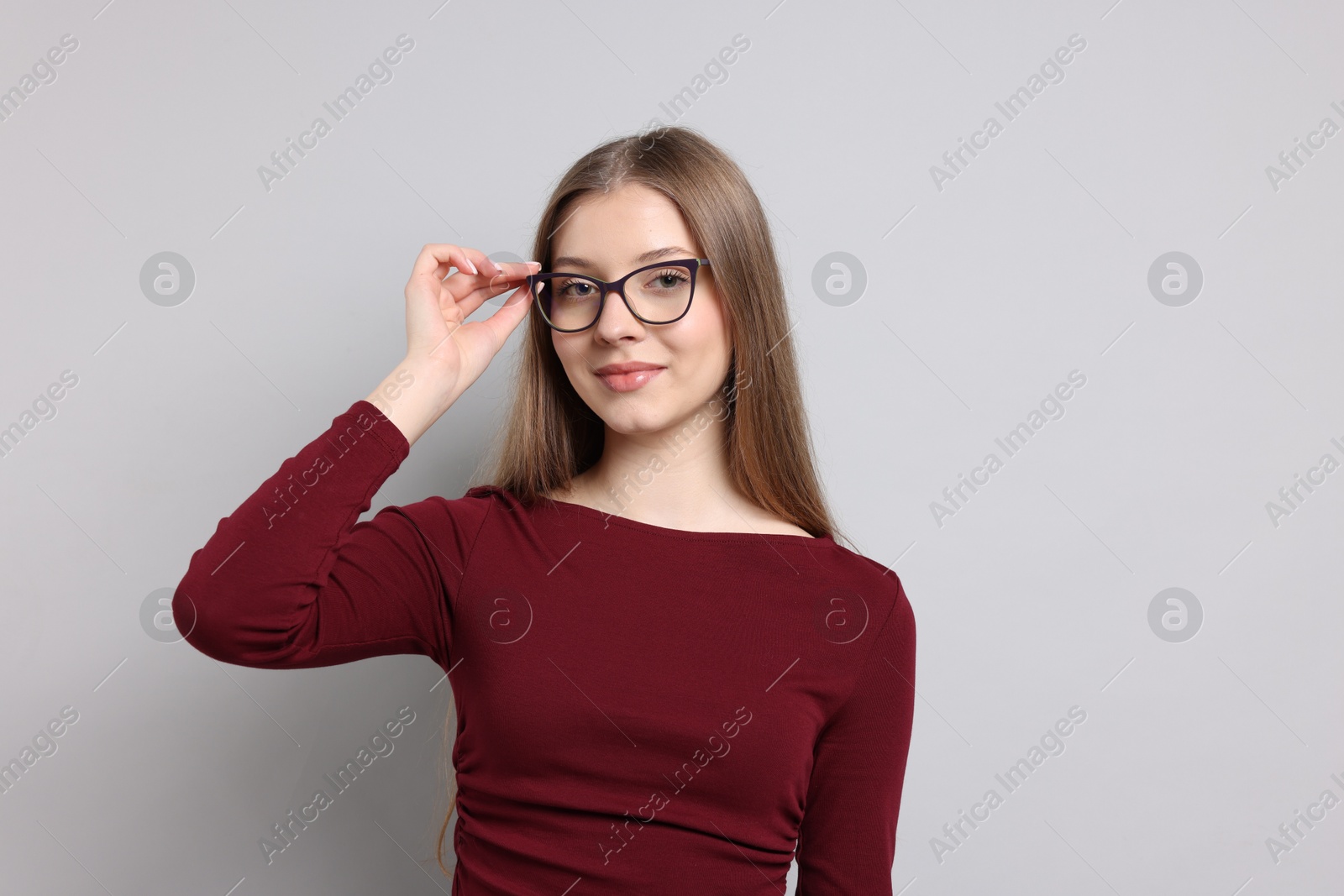 Portrait of teenage girl on light grey background Photo of Portrait of teenage girl on light grey background