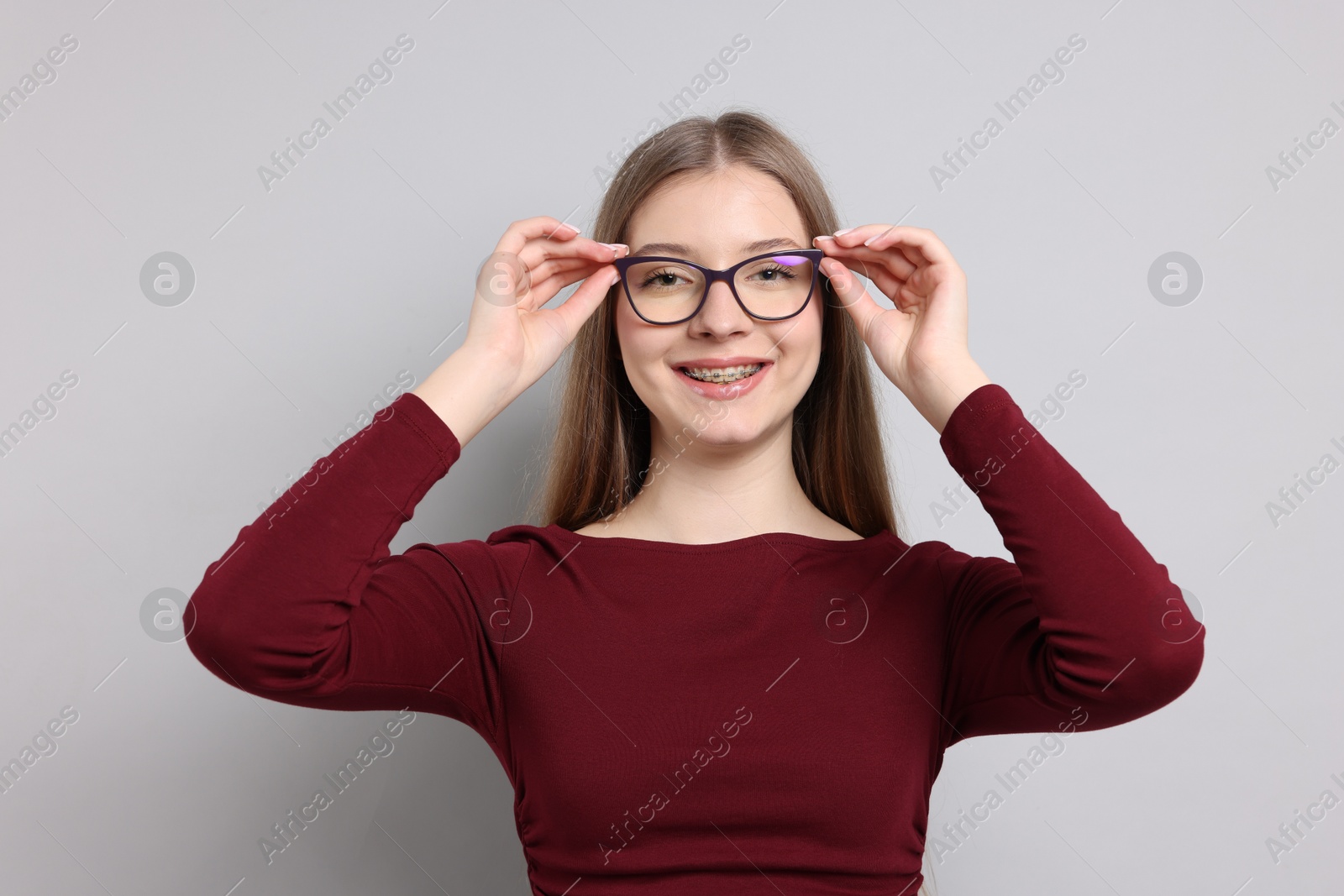 Portrait of teenage girl on light grey background Photo of Portrait of teenage girl on light grey background