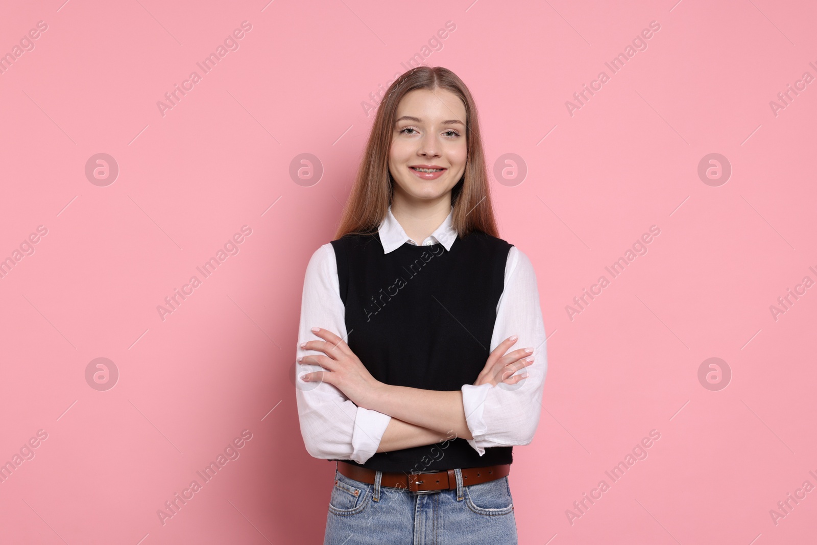 Portrait of teenage girl on light pink background Photo of Portrait of teenage girl on light pink background