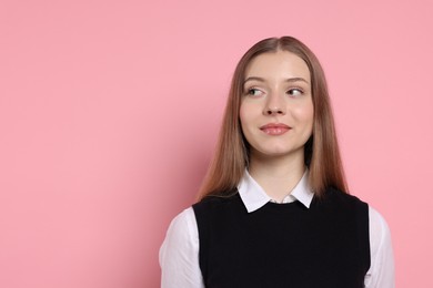 Photo of Portrait of teenage girl on light pink background. Space for text