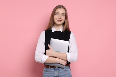 Photo of Beautiful teenage girl with laptop on pink background