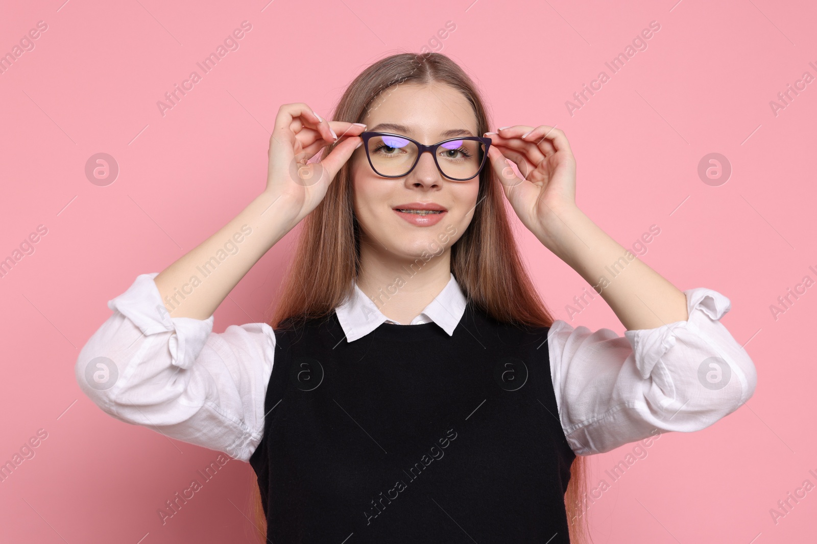 Photo of Portrait of teenage girl on light pink background